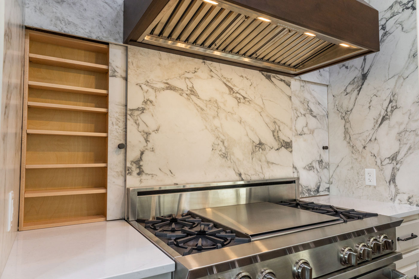 Austin Kitchen Remodeler shows Stove Cabinets open